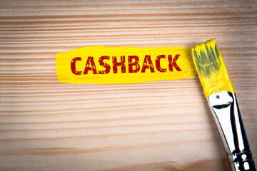 CASHBACK. Yellow paint and paint brush on wooden texture background - 786635519