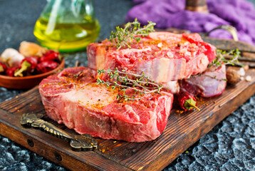 Top view of raw meat pieces placed on wooden tray sprinkled with salt - 786636154