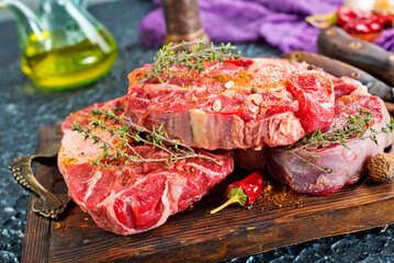Top view of raw meat pieces placed on wooden tray sprinkled with salt - 786636353