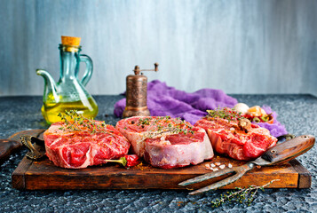 Top view of raw meat pieces placed on wooden tray sprinkled with salt - 786636359