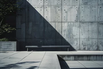 Foto op Plexiglas Stark shadows cast on a minimalist concrete wall and pavement, with a solitary bench invoking contemplation and modern design.   © Kishore Newton