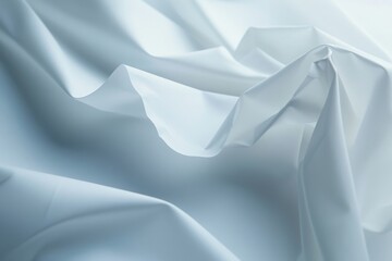 Close-up of a delicate white fabric with a soft, flowing texture, perfect for luxurious backgrounds or fashion design.

