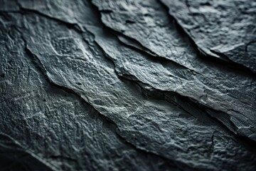 Monochromatic texture of rugged slate, showcasing layers and depth, a versatile image for rustic or sophisticated design elements.


