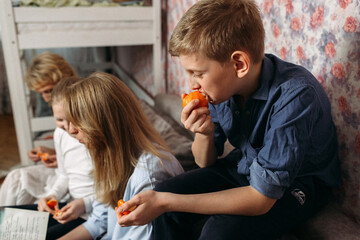 Boy and Girl Sitting on Floor Eating Food