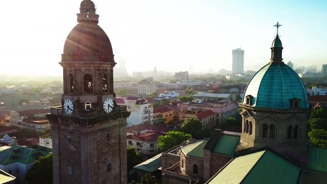 Aerial Panning Beautiful Shot Of Famous Cathedral Church In Residential City Against Clear Sky - Manila, Philippines