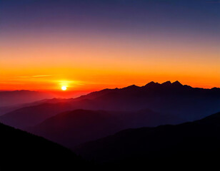 Fototapeta premium the sun is setting over a mountain range with mountains in the foreground and a red sky in the background
