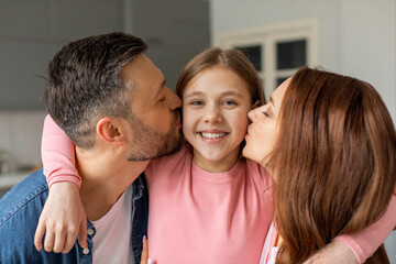 Family moments with affectionate parents kissing child