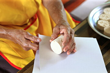 Grandma is packing Chinese traditional pancake snacks into packages made of Rice-Flour (Roasted and...