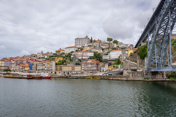 View from Douro River bank in Vila Nova de Gaia on Porto city, Portugal. Episcopal Palace in the middle - obrazy, fototapety, plakaty