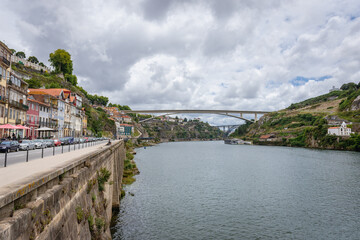 Gustavo Eiffel Avenue along bank of Douro River in Porto city, Portugal. View with Infante Dom Henrique Bridge