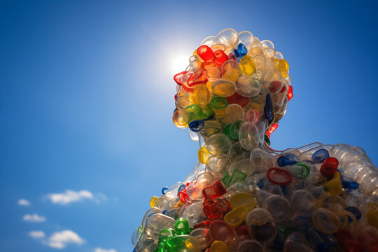 Upcycled plastic sculpture under a clear blue sky. Generative AI image