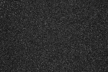 Black sand beach texture as background, top view. Macro photography. Black sand background.