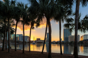 Orlando city skyline at sunset with fountain view of Orlando in Lake Eola Park, Florida, USA
