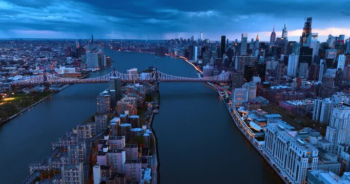 The Queensboro Bridge crossing the East River connecting Manhattan to Queens. Scenic view of amazing New York from top at dusk.