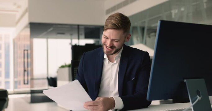 Young businessman get letter with good unbelievable news, celebrating success, enjoy business or professional achievement, reach financial milestones, read positive feedback from client or stakeholder