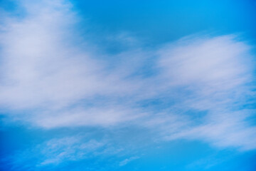 White clouds in the blue sky, close-up of clouds in the blue sky, light on the clouds in the sky