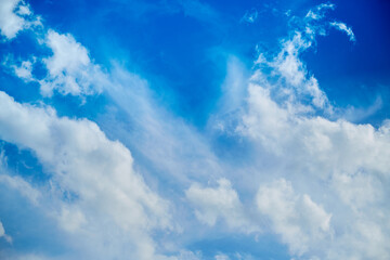 Naklejka na ściany i meble White clouds in the blue sky, light on the clouds in the sky