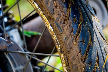 The motorbike tires were covered with thick mud and dry grass stuck to it