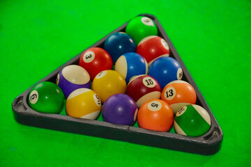 Pyramid of balls on a pool table, starting position for a pool game, balls on a pool table, start of the game