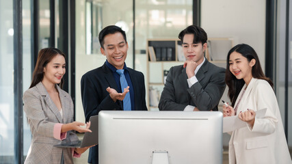 Business associates discussing over laptop computer in office. Casual business meeting. Communication and technology concept