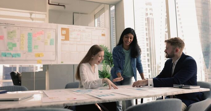 Marketing department analyze performance metrics of marketing campaigns represented in charts and graphs, make ROI or comparative data analysis, reveal trends and market dynamics in modern boardroom