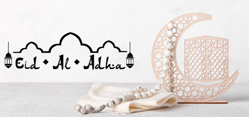 Decorative crescent, hat and Muslim prayer beads on light background