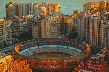 Aerial view over the bull fighting ring and the beach towards the sea