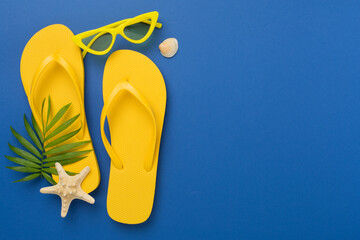 Bright yellow flip-flops on color background, top view. Summer concept