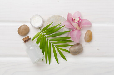 Obraz na płótnie Canvas Composition with orchids, spa products on wooden background, top view