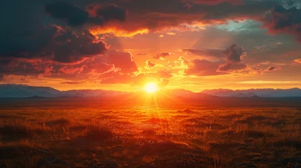 Gordijnen Stunning sunrise over open landscape with bright orange skies and mountain backdrop © Yusif