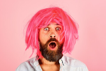 Portrait of surprised man with beard and mustache in colorful wig. Emotions. Party time. Fashion...