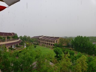 Obraz premium Beautiful view of sky and plantation from a resort on a rainy day