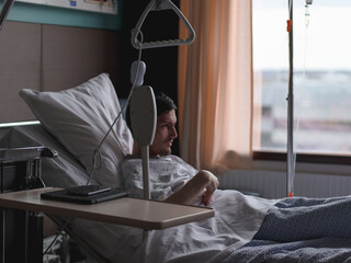 Young man patient lying in the hospital ward.