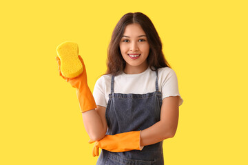 Young woman with sponge on yellow background