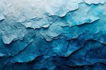 Obraz premium Layers of crumpled paper in various shades of blue, artistically arranged to mimic the flowing pattern of ocean waves.