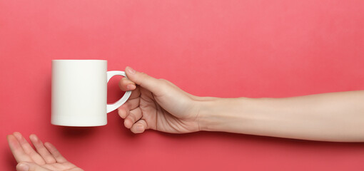 Hand Holding Blank Coffee Mug By Handle on Color Background