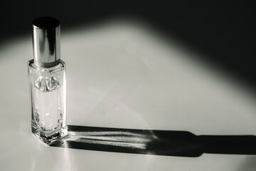small perfume bottle, close-up. black and white. 