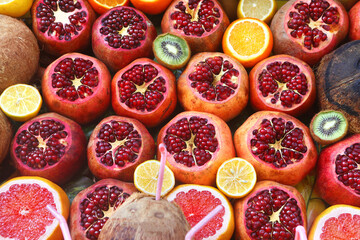 Healthy fresh fruit rich in vitamin C: pomegranates, lemons, oranges, kiwi