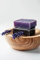 Obraz na płótnie Canvas Three soap bars in a wooden bowl with lavender flowers. Ideal for spa and beauty products concept