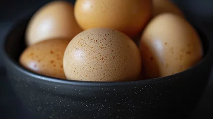 Rolgordijnen Close up of eggs in a black bowl celebrating national egg day © 2rogan