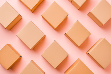 Group of brown cardboard boxes different size on pastel pink background. Mock up. Top view