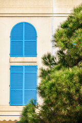 Windows, closed with blue shutters - scenery from Menton, Provence