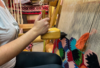 A woman weaving a Pirot carpet on a loom, Serbia