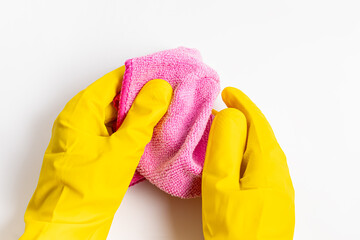 Woman or man in yellow rubber gloves holds pink dust cloth on white background. House cleaning, cleaning service