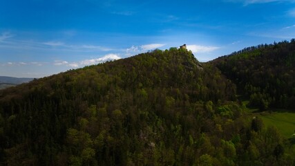 Medieval Chojnik Castle atop Karkonosze mountain in aerial shot.