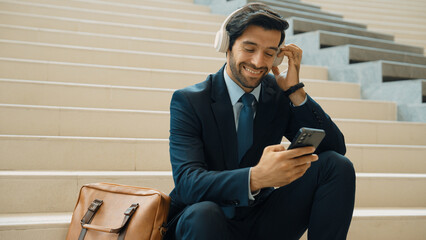 Smart business man listening and enjoy music while wear headphone. Profession project manager...