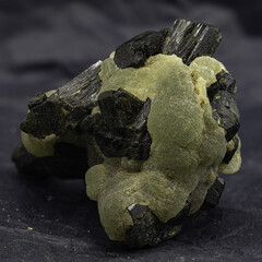 This captivating specimen features prehnite's botryoidal texture and glowing green hue, accented by...