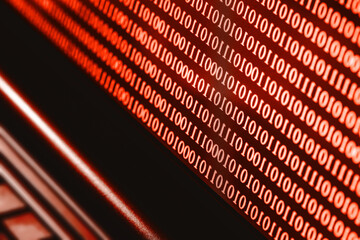 Binary code on computer screen. Hacker background. Red alert background. Internet search.