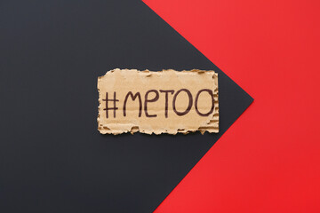 Torn cardboard paper with hashtag METOO on color background