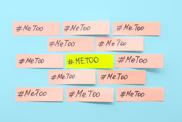 Paper sheets with hashtags METOO on blue background
